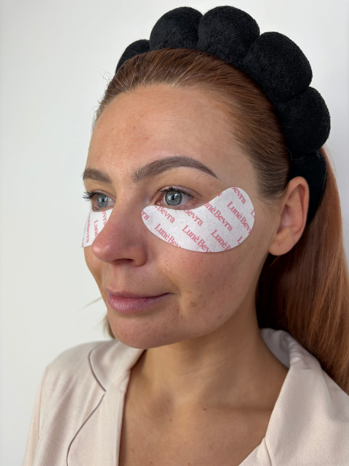 Woman wearing LunèBevra under-eye patches